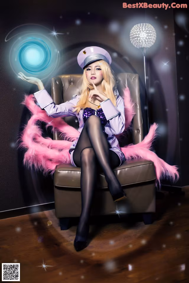 A woman sitting on a chair holding a crystal ball.