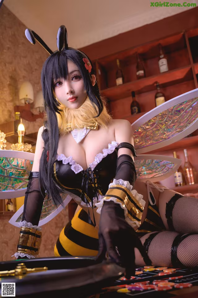A woman dressed as a bee sitting at a table.