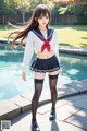 A woman in a sailor outfit posing by a pool.