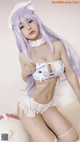 A woman with long purple hair wearing a white lingerie.